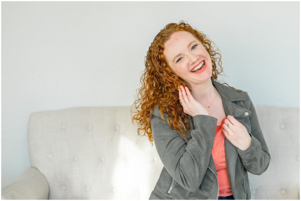 Image from branding photoshoot for Bethany Collins Consulting shows a girl with red curly hair smiling at the camera.