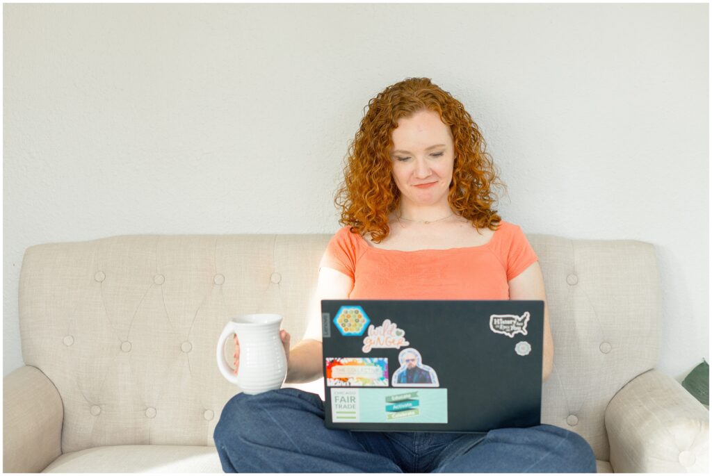 Image from branding photoshoot for Bethany Collins Consulting shows a girl with red curly hair working on a computer.